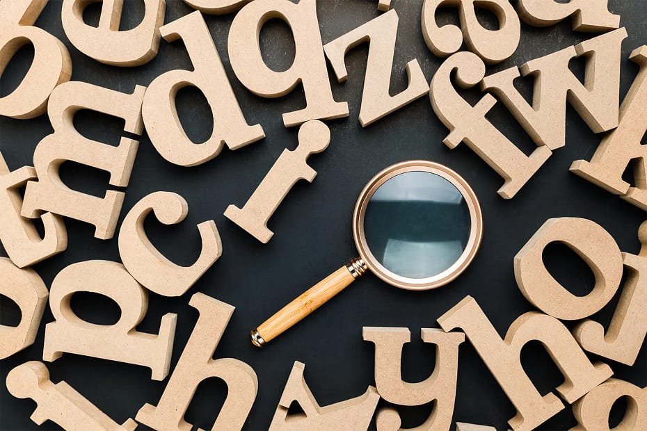 The Ultimate Glossary of AI Search Terms for Brands - Letters and Magnifying Glass