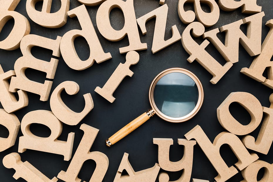 The Ultimate Glossary of AI Search Terms for Brands - Letters and Magnifying Glass